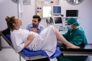doctor-examining-pregnant-woman-delivery-while-man-holding-her-hand-1024x683