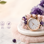 Beaded watch bracelet with rose gold watch face, crystal beads, essential oil bottle, and soft pastel background in a modern lifestyle setting