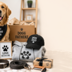 Golden retriever surrounded by dog-themed gifts including apparel, toys, mug, leash, and gift box in a modern indoor setting