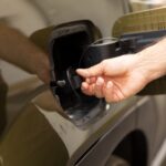 closeup-man-opening-ev-vehicle-inlet-port-attach-electric-cable (2) (1)