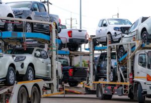 car-carrier-trailer-transport-new-car-from-manufacturing-factory-dealer-auto-vehicle-haul-truck-delivery-transport-logistics-automotive-industry-car-carrier-trailer-load-new-car-shipping_33867-1978