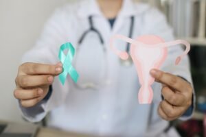 Doctor,Hands,Showing,Teal,Awareness,Ribbon,With,Cervix,Shape.,Ovarian